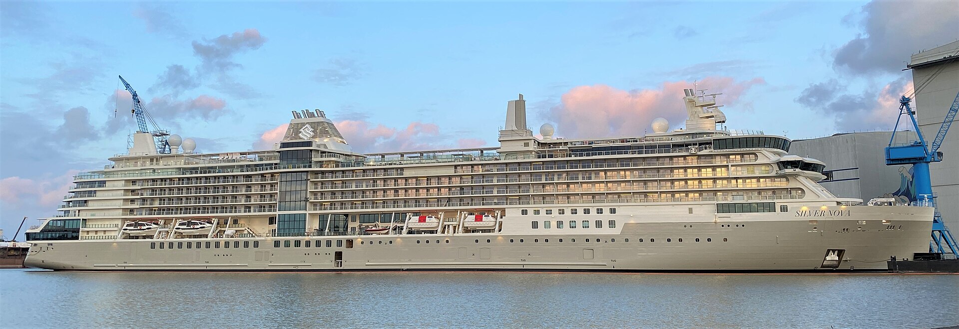 Silversea Nova Class At Q2 2026 — photo illustration accompanying Cruises Desk brief from Business Travel Today. Silver Nova (Aug 2023) and Silver Ray (Jun 2024) anchor Silversea's Nova class. Royal Caribbean Group ownership is the capital structure behind the run.